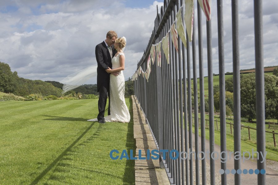 bride and groom by railings