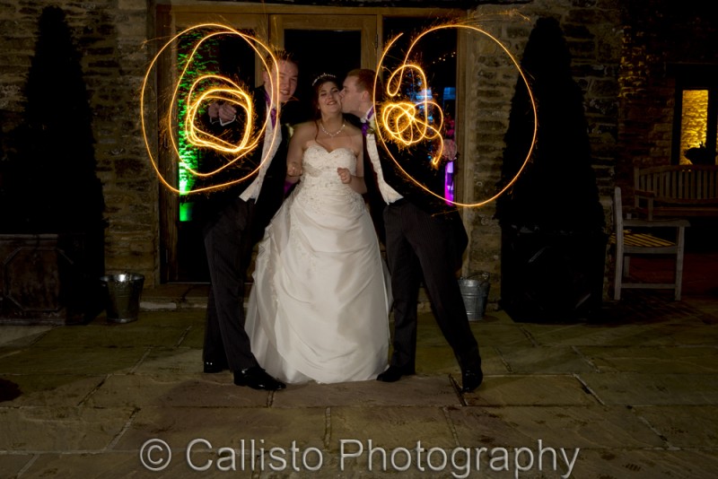 best man and groom twirl sparklers