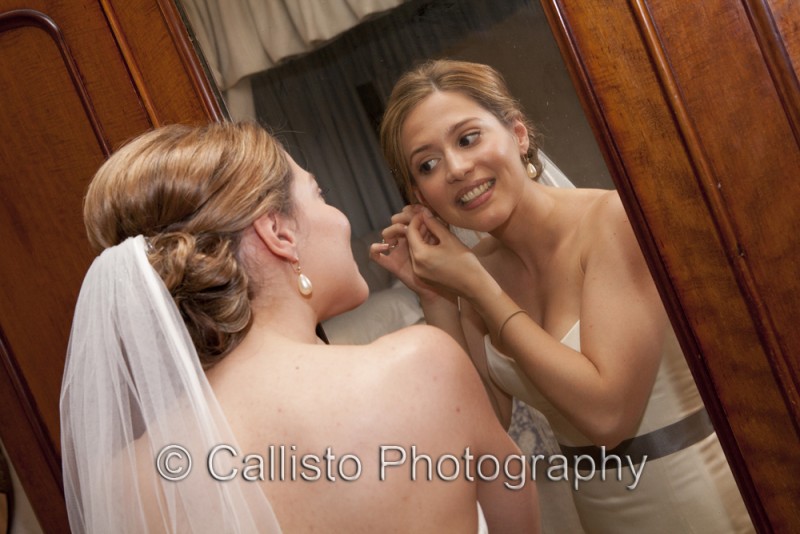 bride donning earrings