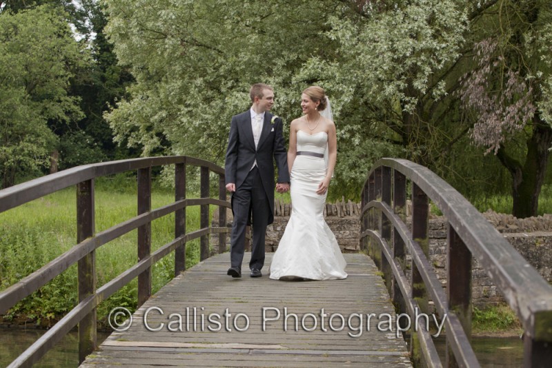 bride and groom crossing bridge