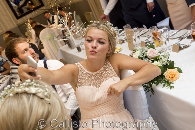 bridesmaid doing selfie at reception