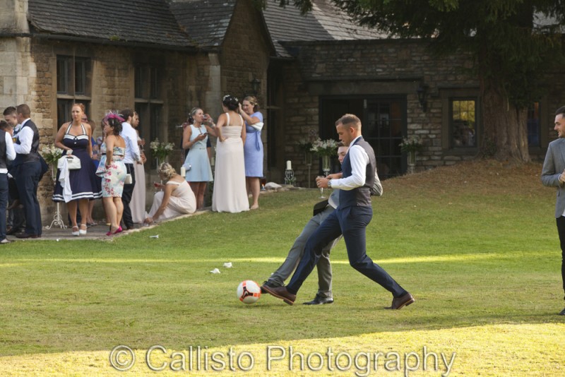groom playing football at wedding