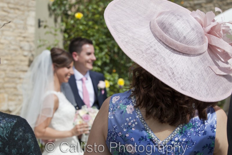 pink hat with bride and groom