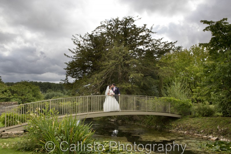 bride and groom over duck pond